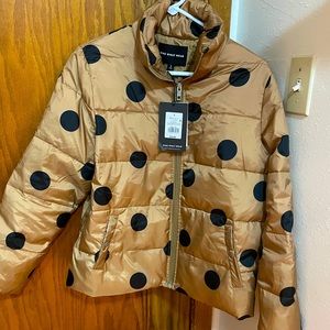 Woman's gold polkadot coat